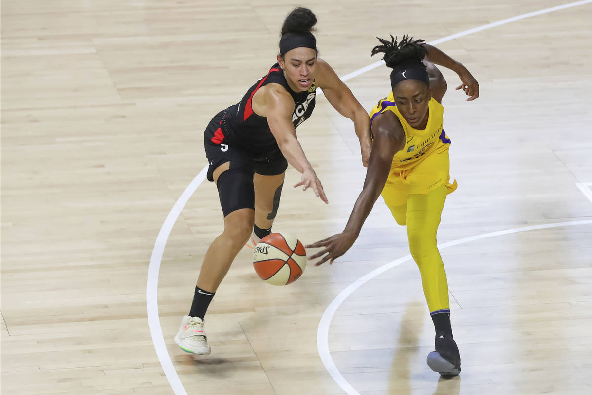Las Vegas Aces' Dearica Hamby, left, reaches for a loose ball against Los Angeles Sparks' Nneka ...
