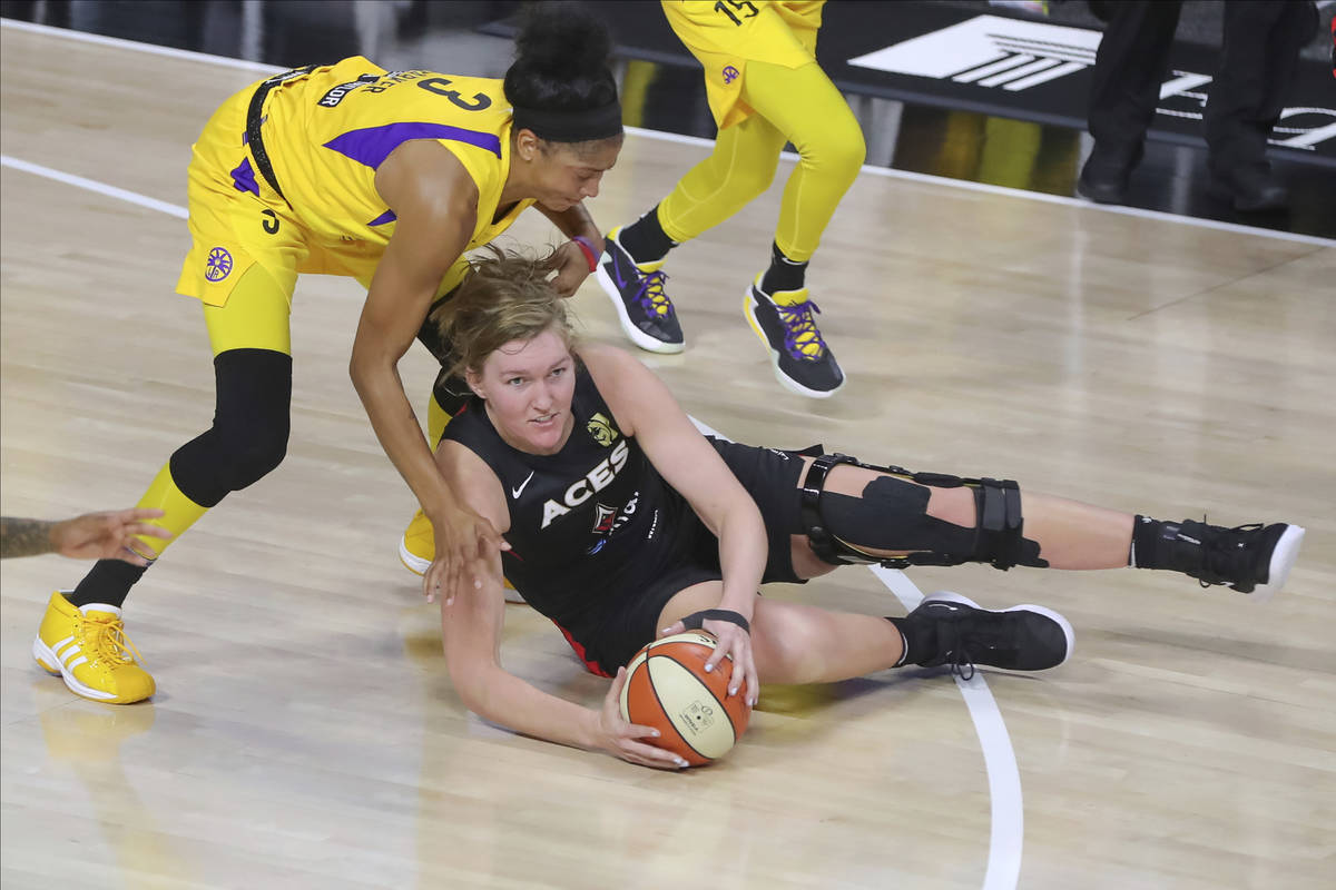 Los Angeles Sparks' Candace Parker (3) reaches over Las Vegas Aces' Carolyn Swords during the s ...
