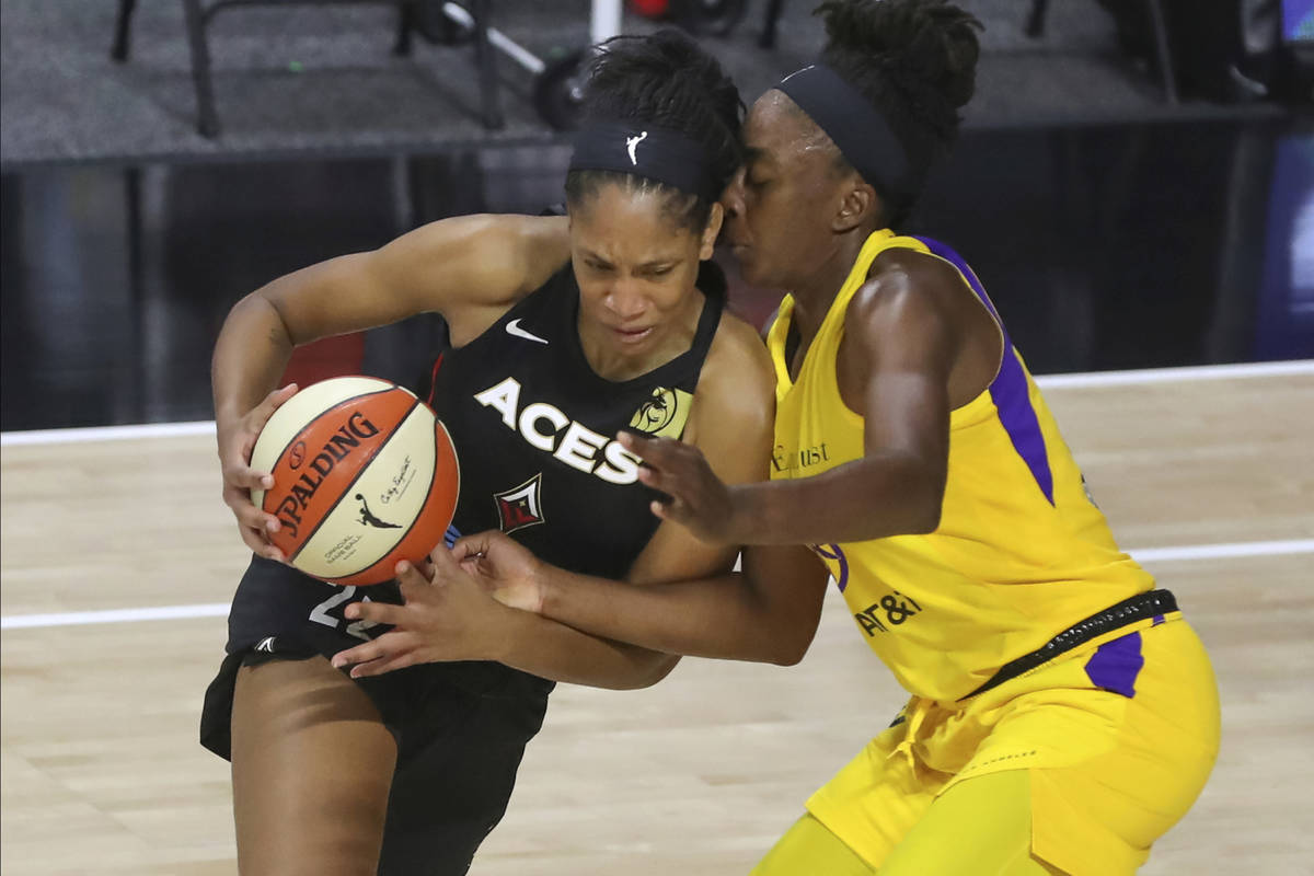 Las Vegas Aces' A'ja Wilson, left, drives against Los Angeles Sparks' Nneka Ogwumike during the ...