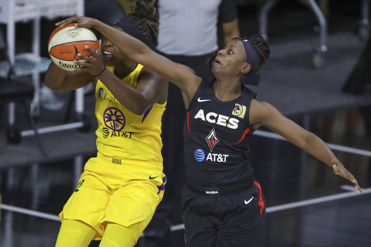 Las Vegas Aces' Sugar Rodgers, right, blocks a shot attempt by Los Angeles Sparks' Chelsea Gray ...