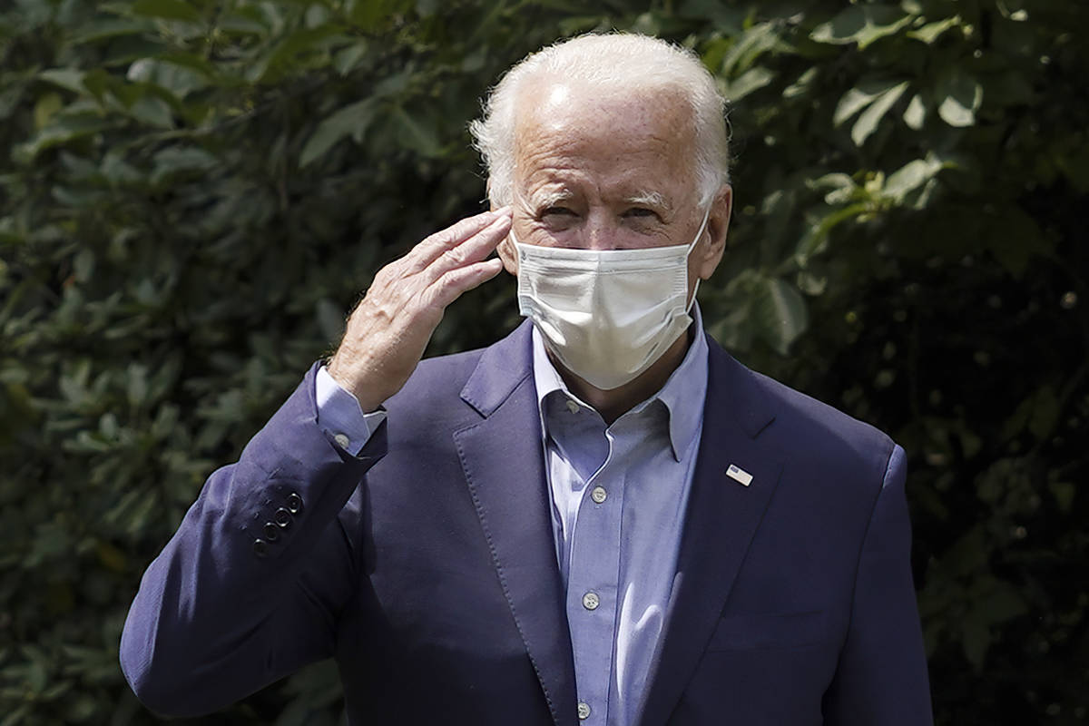 Democratic presidential candidate former Vice President Joe Biden salutes as he arrives for an ...