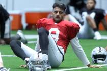 Las Vegas Raiders quarterback Marcus Mariota (8) stretches during a practice session at the tea ...