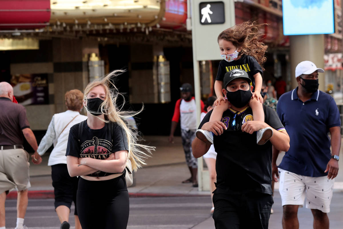 Shiloh, 3, her mother Amanda and father Ruben of Santa Barbara brave high winds as they cross C ...