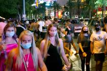 In this Sept. 5, 2020, file photo, a crowd crosses Bellagio Drive on the Las Vegas Strip. (Elle ...