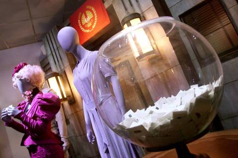 Costumes that were worn by Elizabeth Banks (left), Jennifer Lawrence (right) are on display as ...