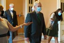 Senate Majority Leader Mitch McConnell of Ky., center, walks to his office from the Senate floo ...