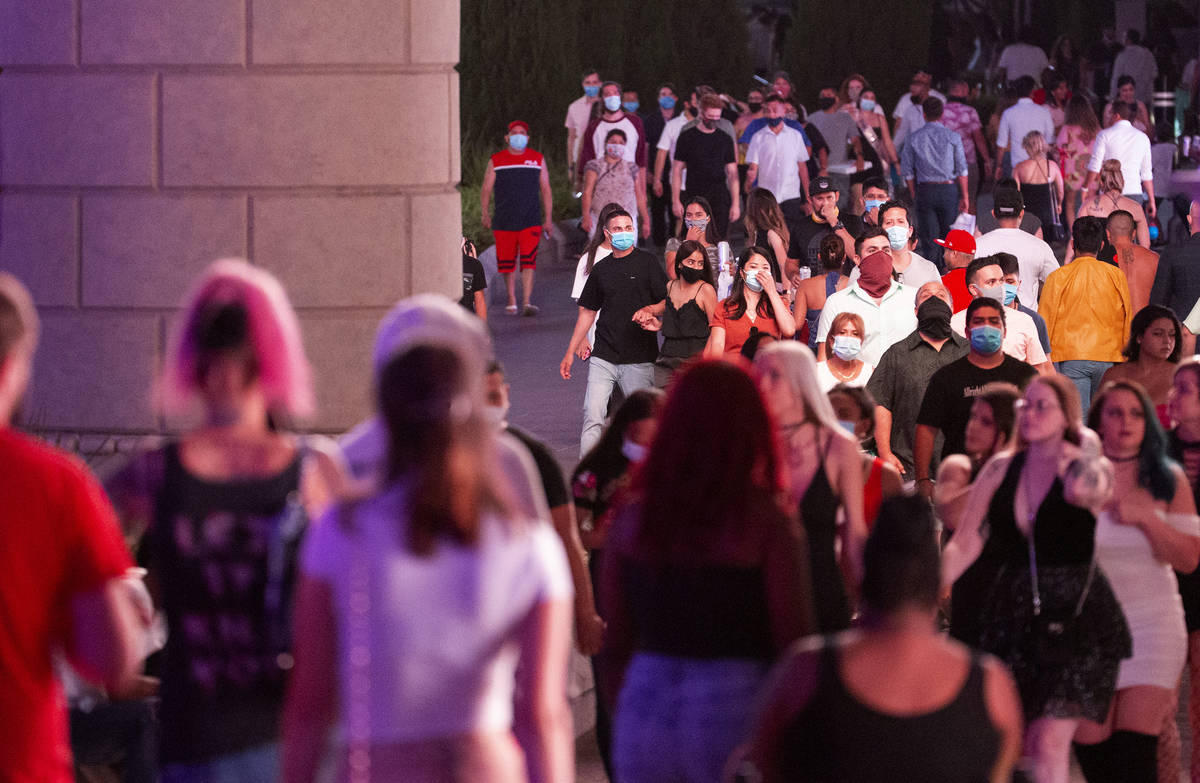 Visitors pass by The Forum Shops at Caesars on the Strip during Labor Day weekend on Saturday, ...