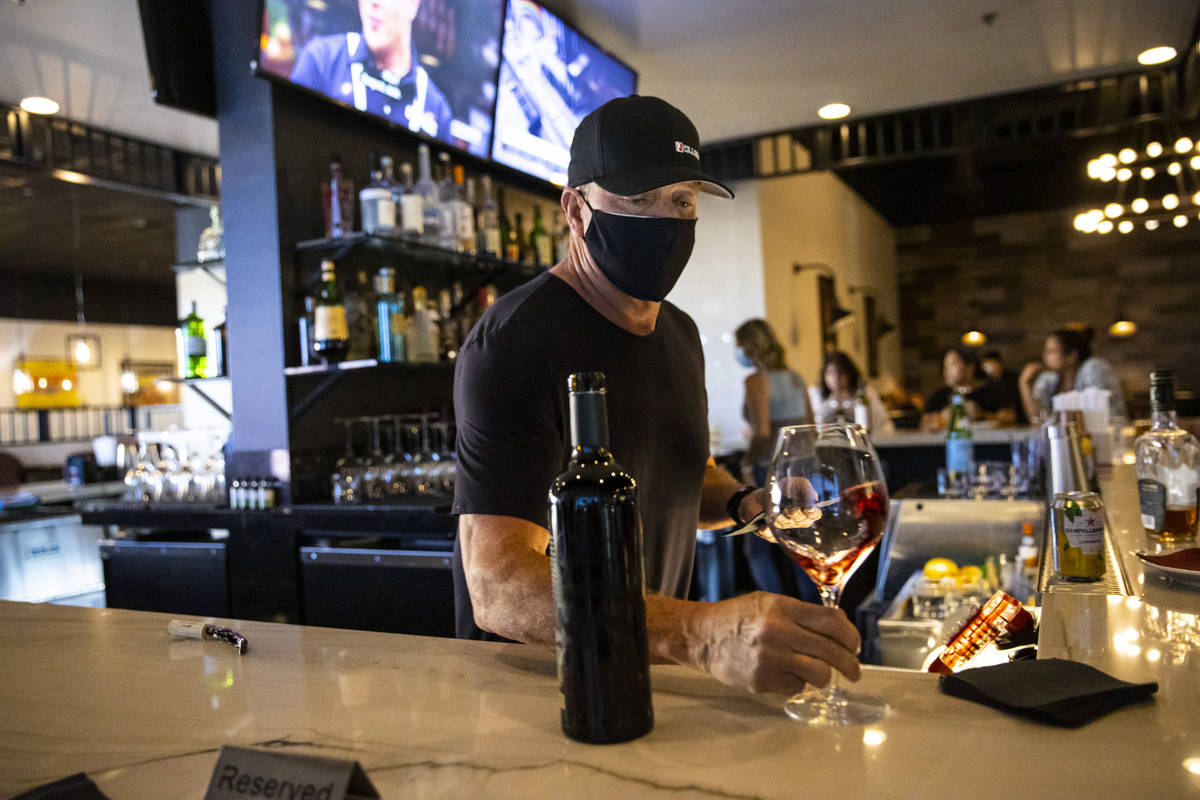 Bar manager David Cooper prepares a glass of wine during happy hour at Spaghetty Western in the ...