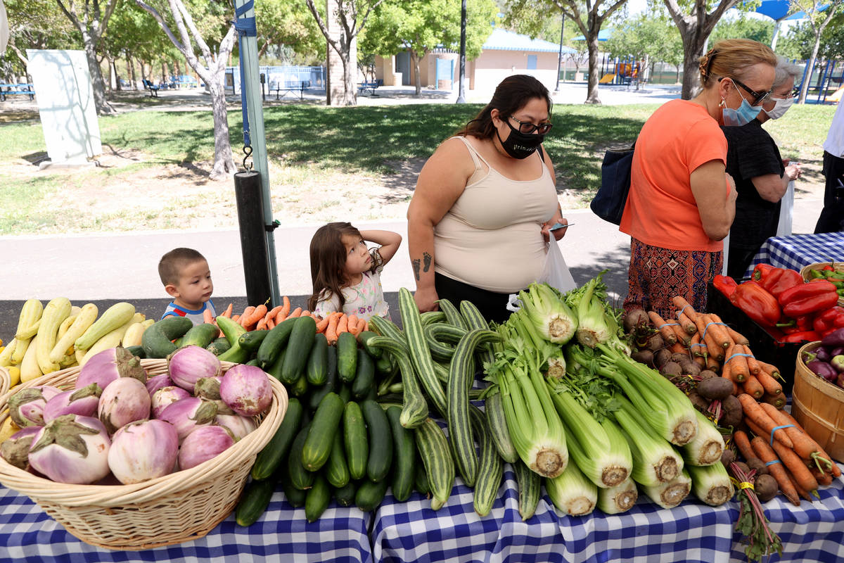 Cindy Larena of Las Vegas shops with her children Arthur, 3, and Angel, 4, at Las Vegas Farmers ...