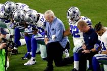In this Monday, Sept. 25, 2017, file photo, the Dallas Cowboys, led by owner Jerry Jones, cente ...