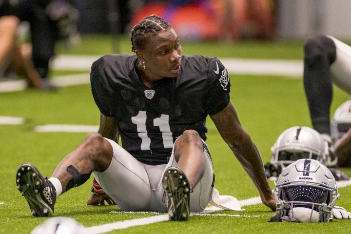 Las Vegas Raiders wide receiver Henry Ruggs III (11) looks to a teammate while stretching durin ...