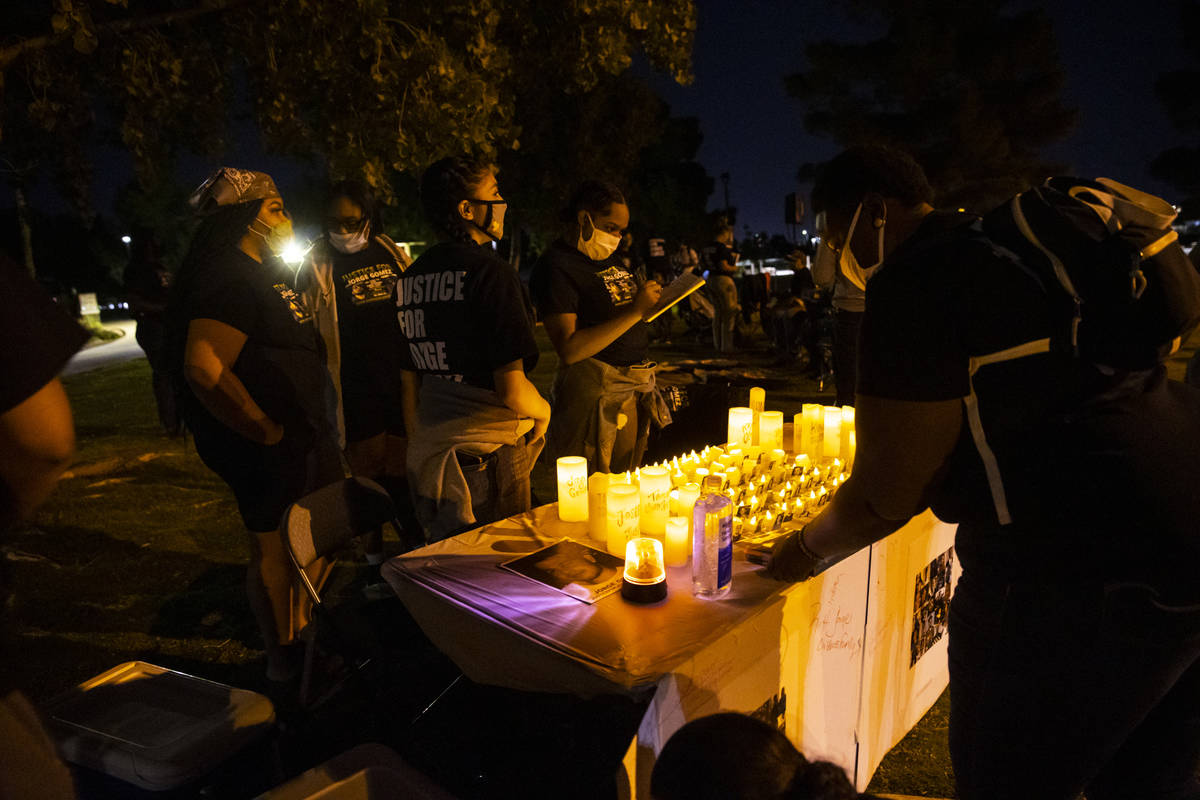 People gather at a candlelight vigil for Jorge Gomez and others who have died from police viole ...