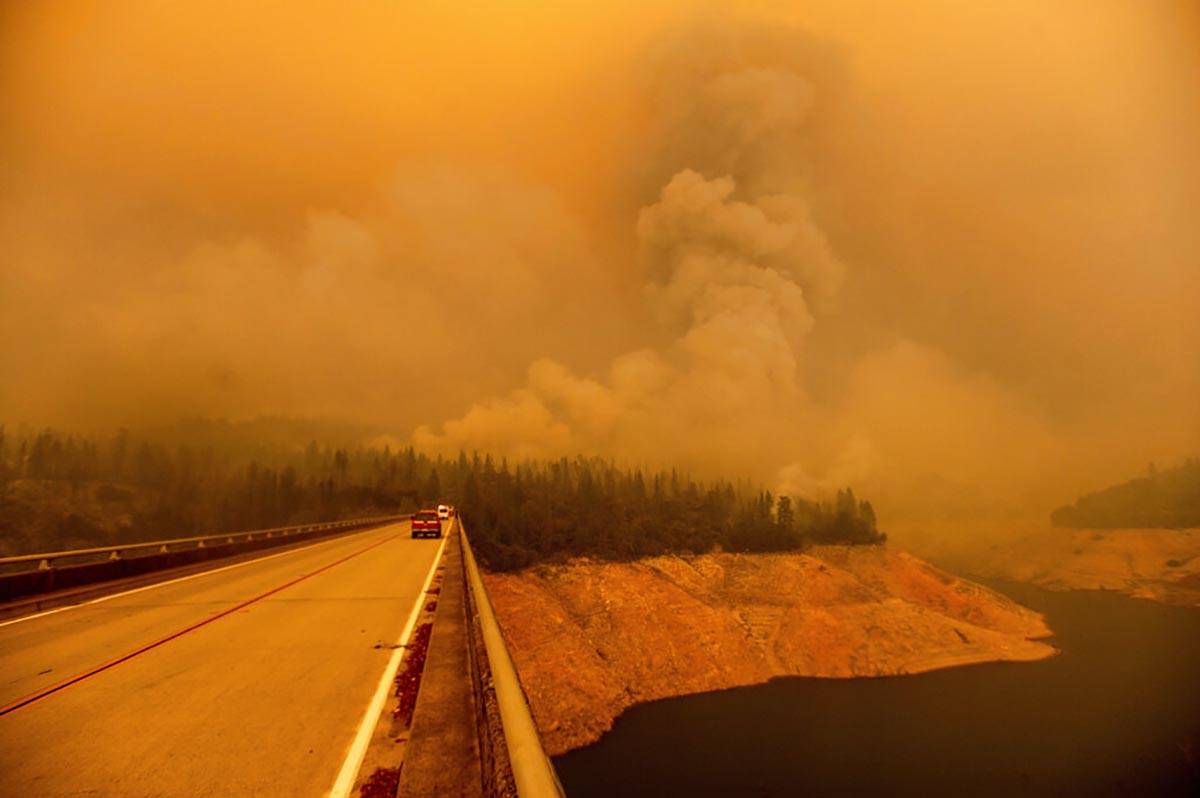 A plume rises from the Bear Fire as it burns along Lake Oroville on Wednesday, Sept. 9, 2020, i ...