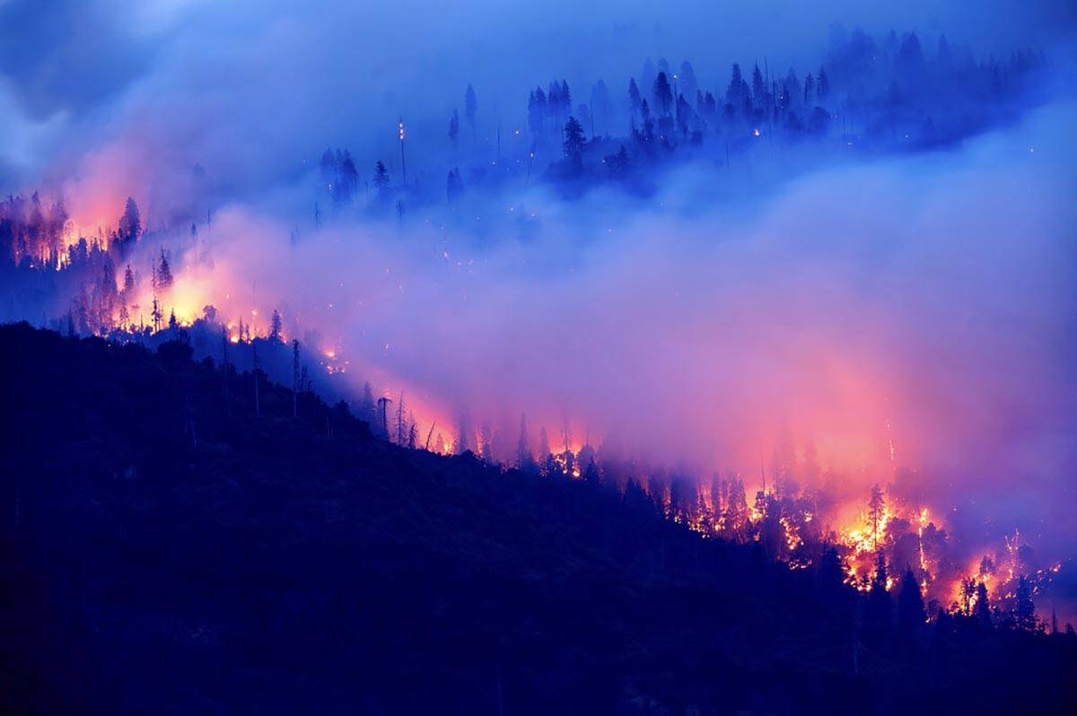 The Creek Fire burns along a hillside in the Cascadel Woods community of Madera County, Calif., ...
