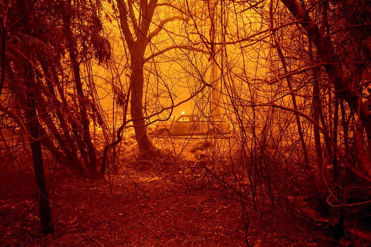 A scorched car rests in a clearing following the Bear Fire in Butte County, Calif., on Wednesda ...