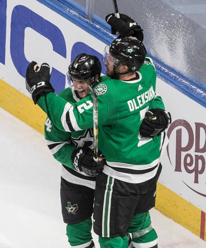 Dallas Stars' Jamie Oleksiak (2) and Miro Heiskanen (4) celebrate a goal against the Vegas Gold ...