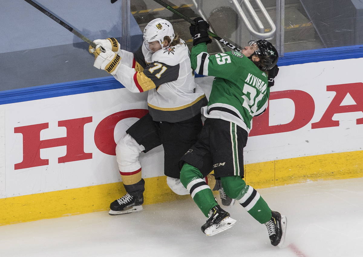 Dallas Stars' Joel Kiviranta (25) checks Vegas Golden Knights' William Karlsson (71) during the ...