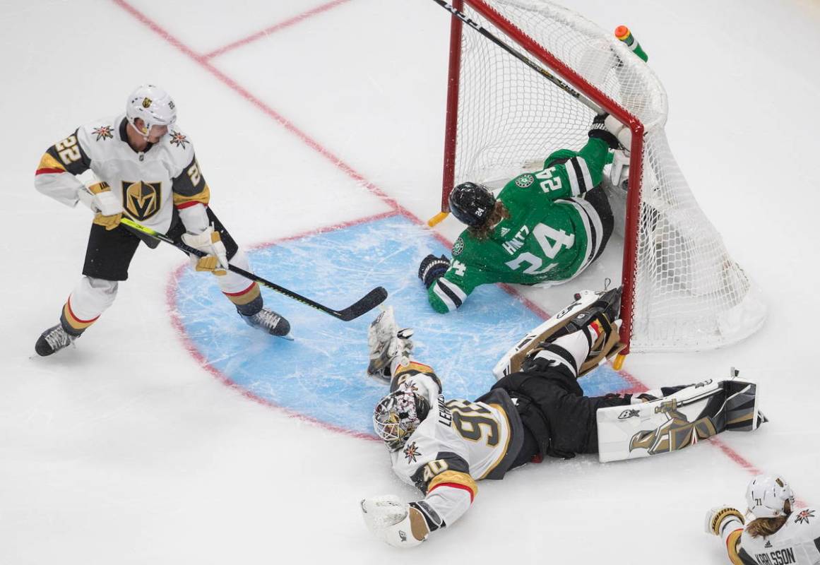 Dallas Stars' Roope Hintz (24) crashes into the net as Vegas Golden Knights goalie Robin Lehner ...