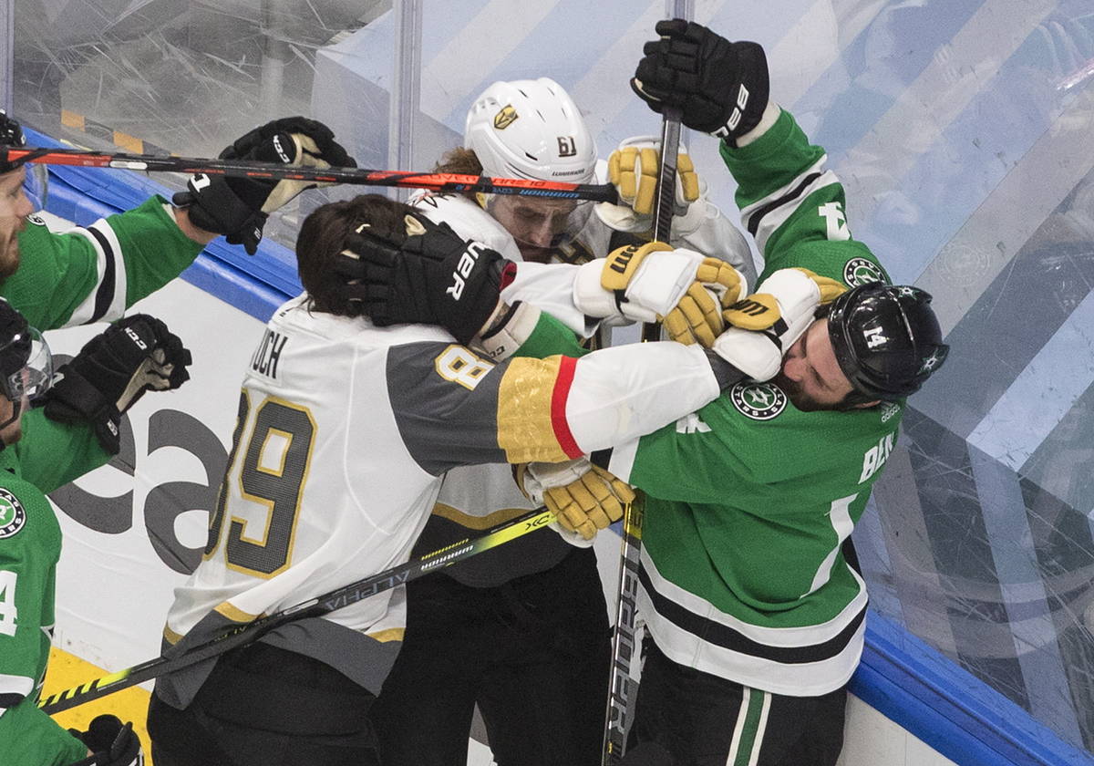 Dallas Stars' Jamie Benn (14) and Vegas Golden Knights' Alex Tuch (89) and Mark Stone (61) batt ...