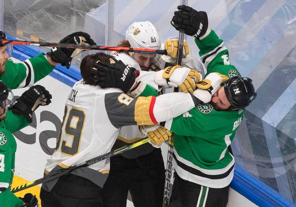 Dallas Stars' Jamie Benn (14) and Vegas Golden Knights' Alex Tuch (89) and Mark Stone (61) batt ...