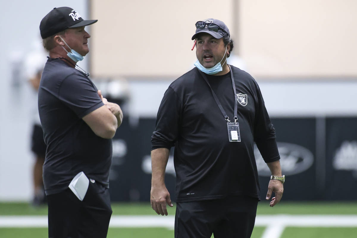 Las Vegas Raiders head coach Jon Gruden, left, talks with defensive coordinator Paul Guenther d ...