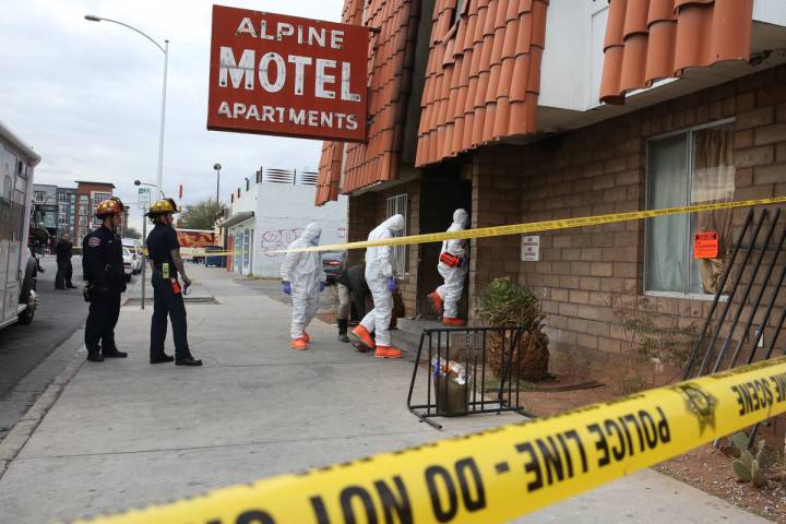 Las Vegas Fire Department investigators with assistance from Las Vegas police enter the Alpine ...