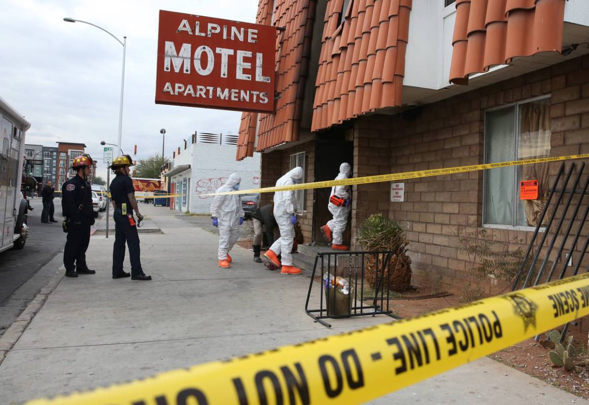 Las Vegas Fire Department investigators with assistance from Las Vegas police enter the Alpine ...