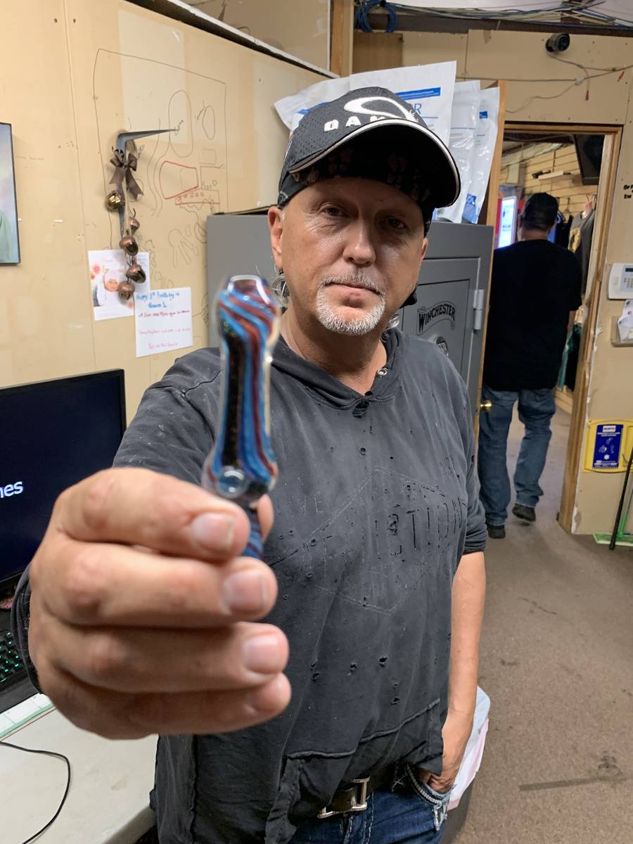 Jeff Lowe is shown with Travis Maldonado's glass pipe at Greater Wynnewood Exotic Animal Park o ...