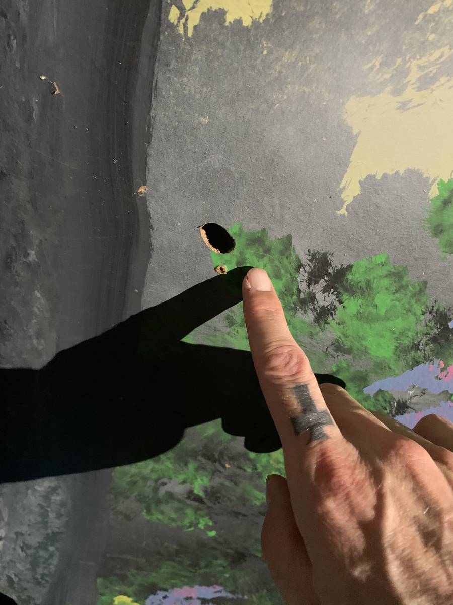 Zak Bagans points to a bullet hole at the scene of Travis Maldonado's suicide at Greater Wynnew ...