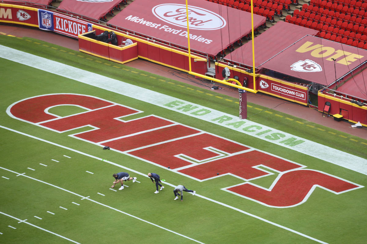 Members of the Houston Texans stretch near a social justice sign in the end zone prior to their ...