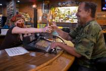 Bartender Teah Heath, left, serves a beer to Lyle Bogggess at Jackson’s Bar & Grill on Thursd ...