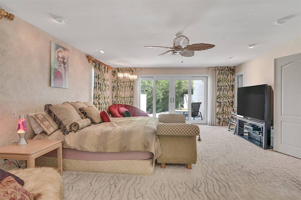 The master bedroom was expanded and remodeled. It opens to the pool area. (Nartey Wilner Group)