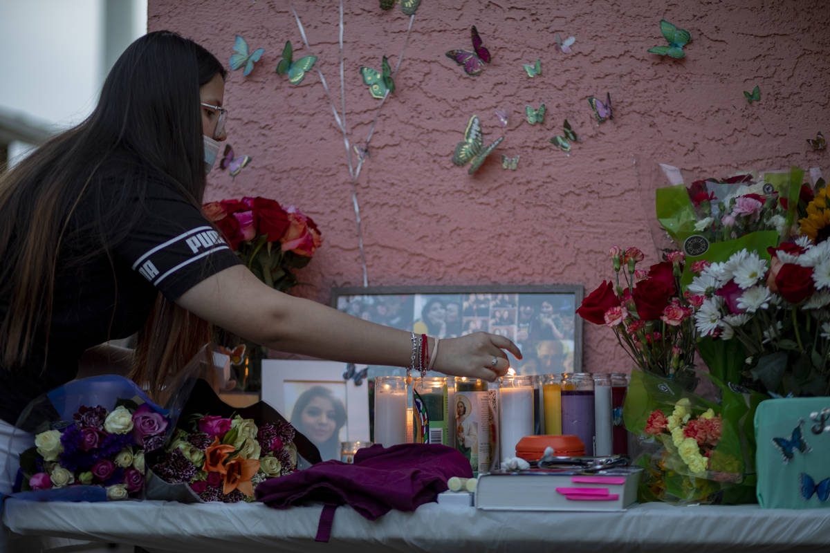Sister of victim Lesly Palacio, Nayelli Palacio, 16, lights candles during a vigil at their mot ...