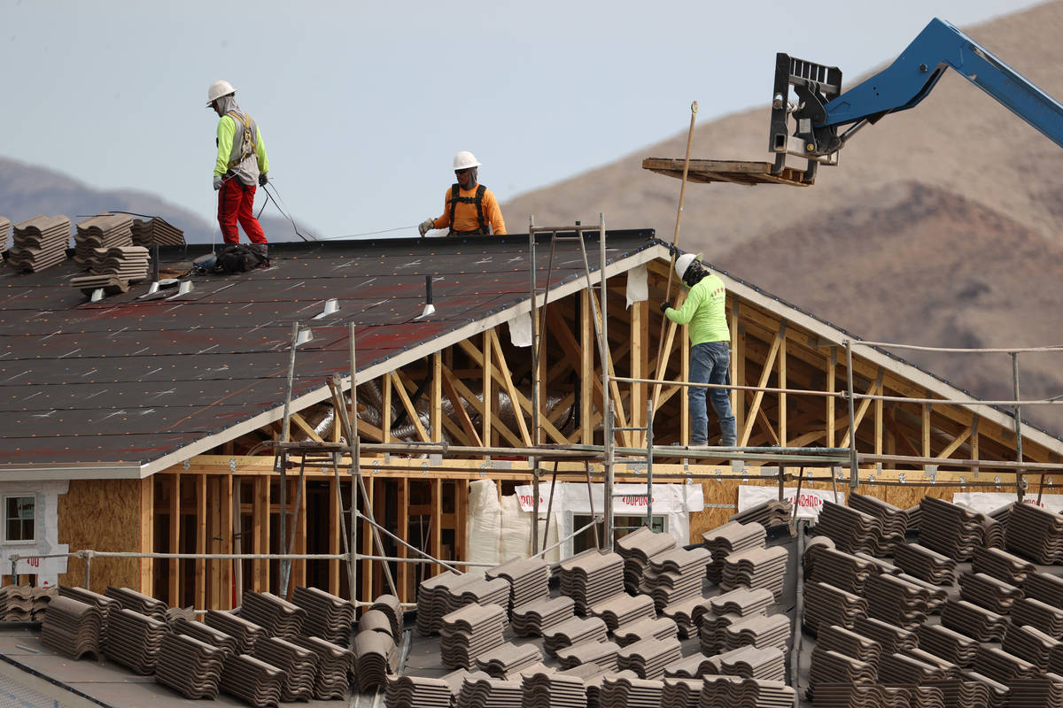Workers on the roof of a home under construction in the Beazer Homes community in Indian Spring ...