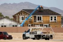 Workers on the roof of a home under construction in the Beazer Homes community in Indian Spring ...