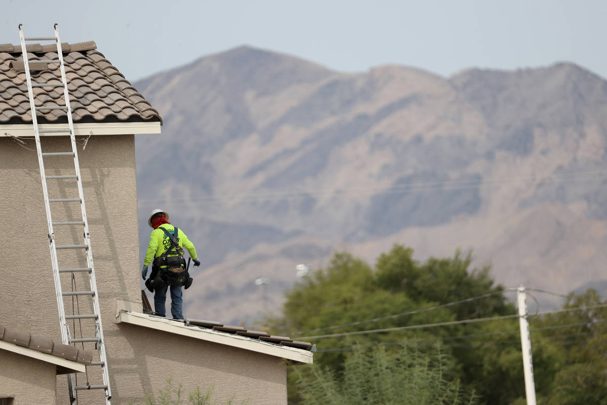 Workers on the roof of a home under construction in the Beazer Homes community in Indian Spring ...