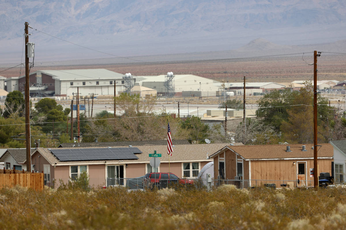 Creech Air Force Base is seen in the distance behind mobile homes at Indian Springs, Friday, Se ...