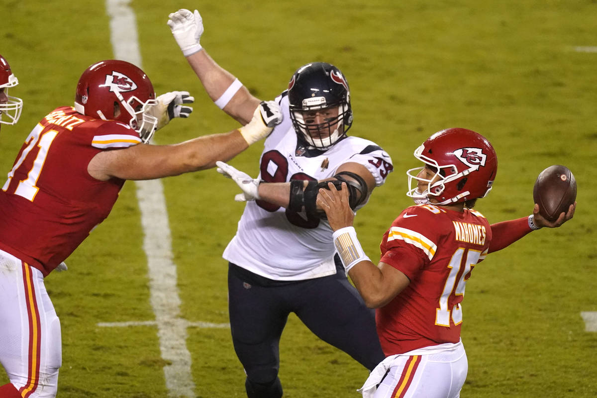 Kansas City Chiefs quarterback Patrick Mahomes (15) passes as he is pressured by Houston Texans ...