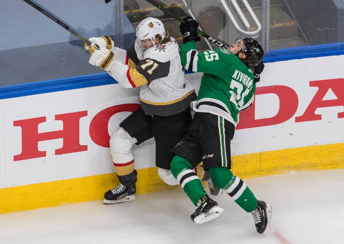 Dallas Stars' Joel Kiviranta (25) checks Vegas Golden Knights' William Karlsson (71) during the ...