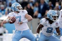 In this Dec. 27, 2019, file photo, North Carolina quarterback Sam Howell throws a touchdown pas ...