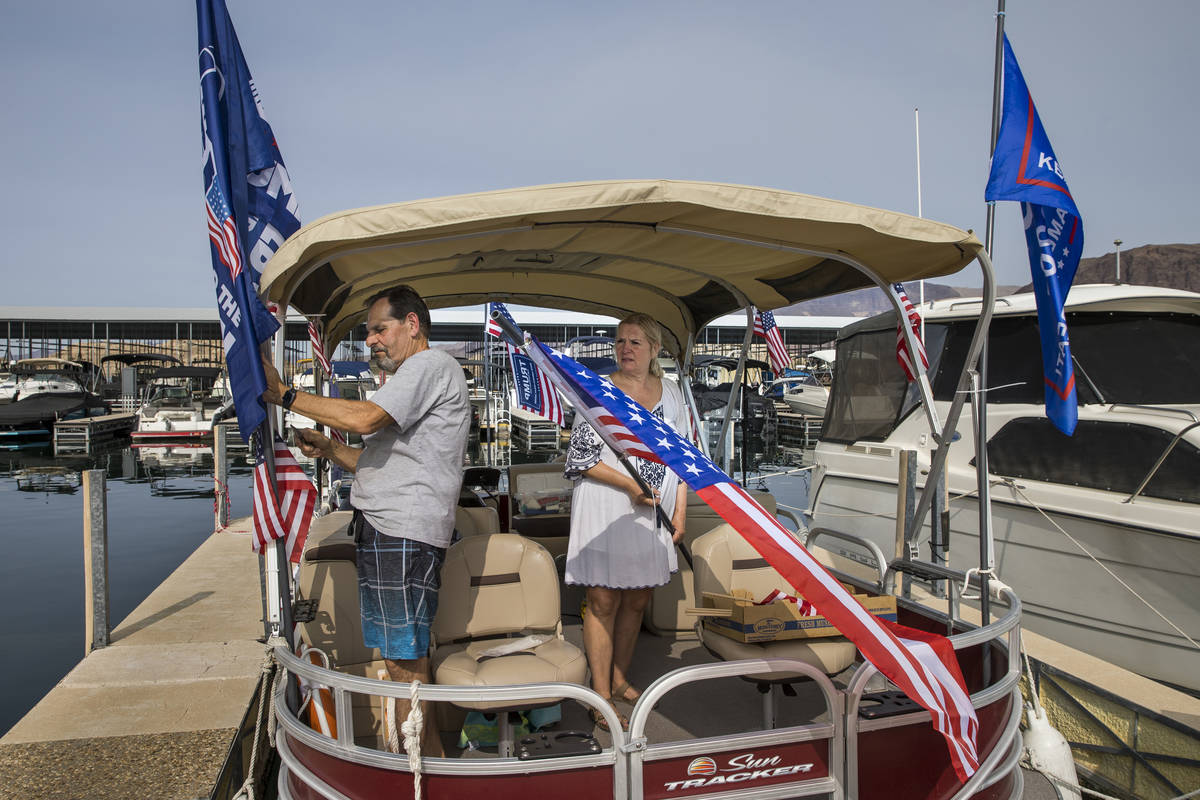 Larry Silvestri, left, and his wife Mary attach 20 flags to their boat while preparing for the ...