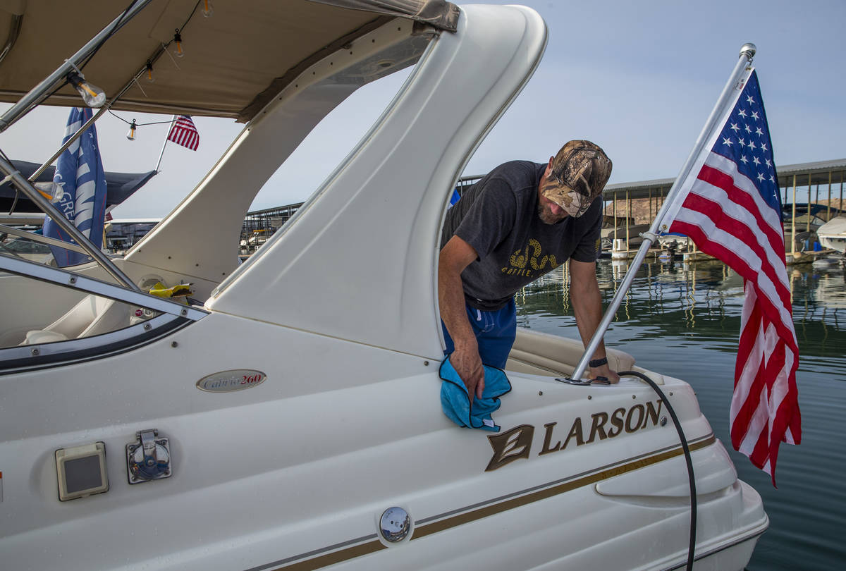 Anthony Carlo spruces up his boat while preparing for the President Donald Trump boat parade Sa ...