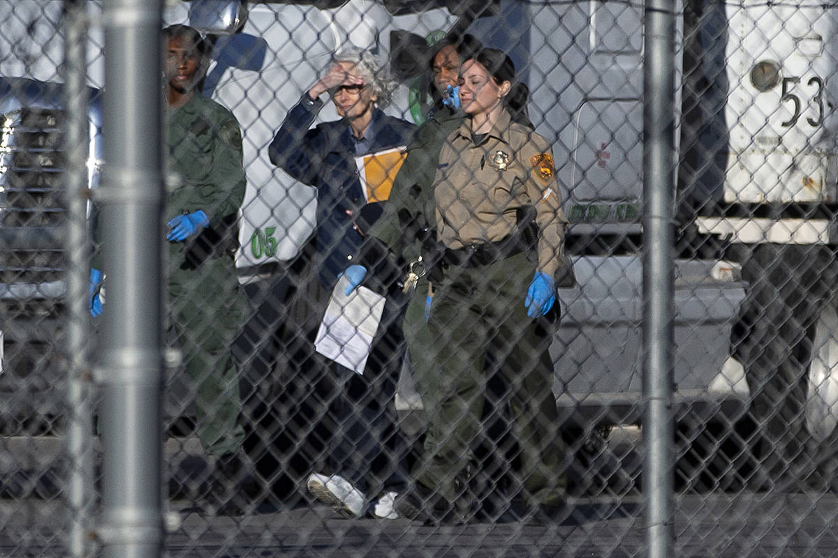 Margaret Rudin, second from left, is escorted out of Florence McClure Women's Correctional Cent ...