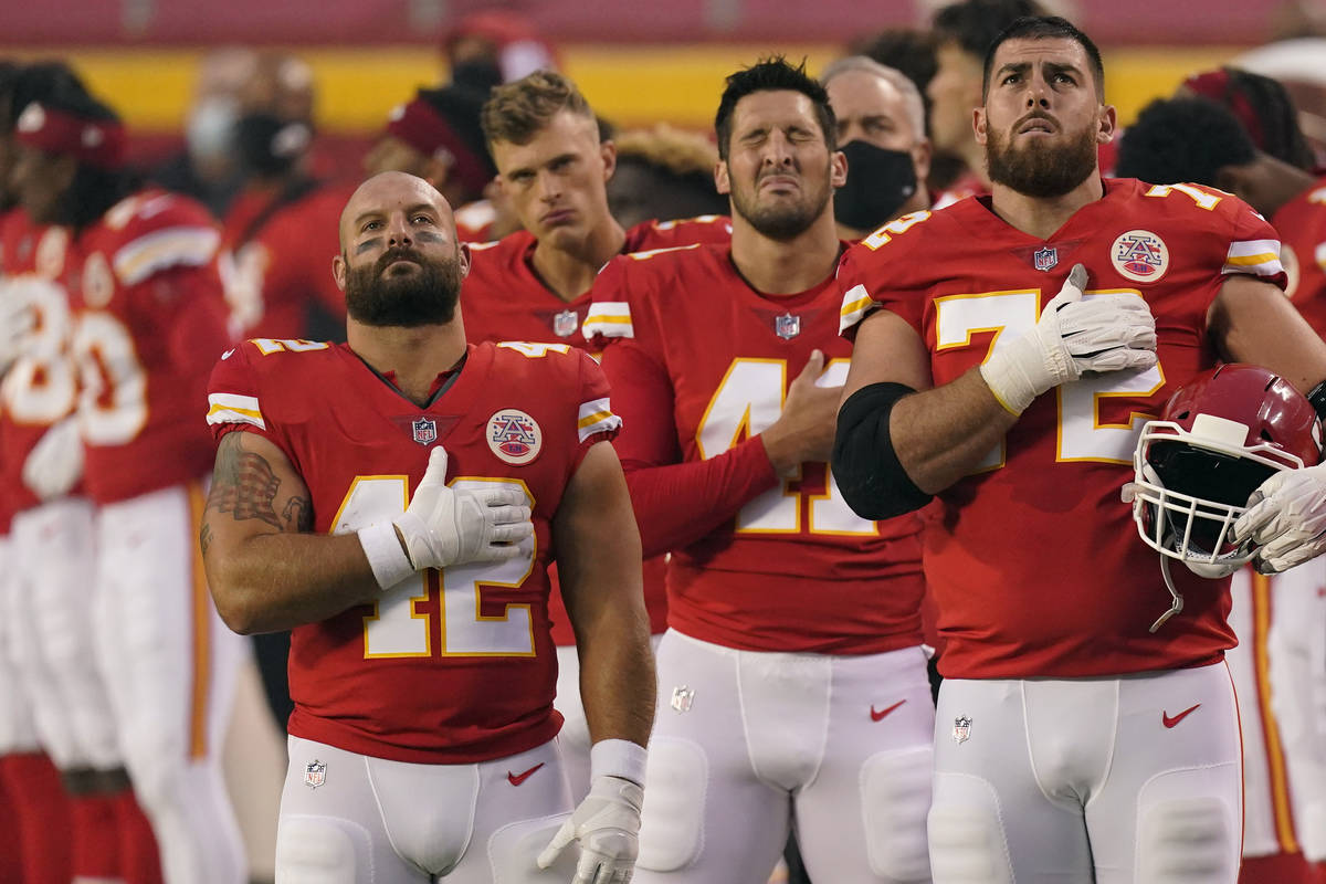 Kansas City Chiefs players stand for the national anthem before an NFL