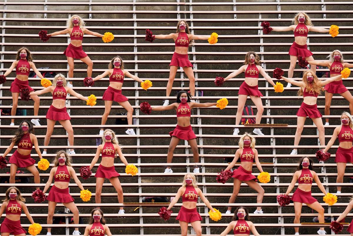 Iowa State cheerleaders perform in the stands before an NCAA college football game against Loui ...