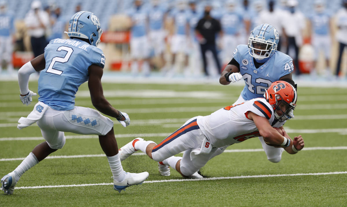 Syracuse quarterback Tommy DeVito (13) dives for extra yardage in the first half of an NCAA col ...