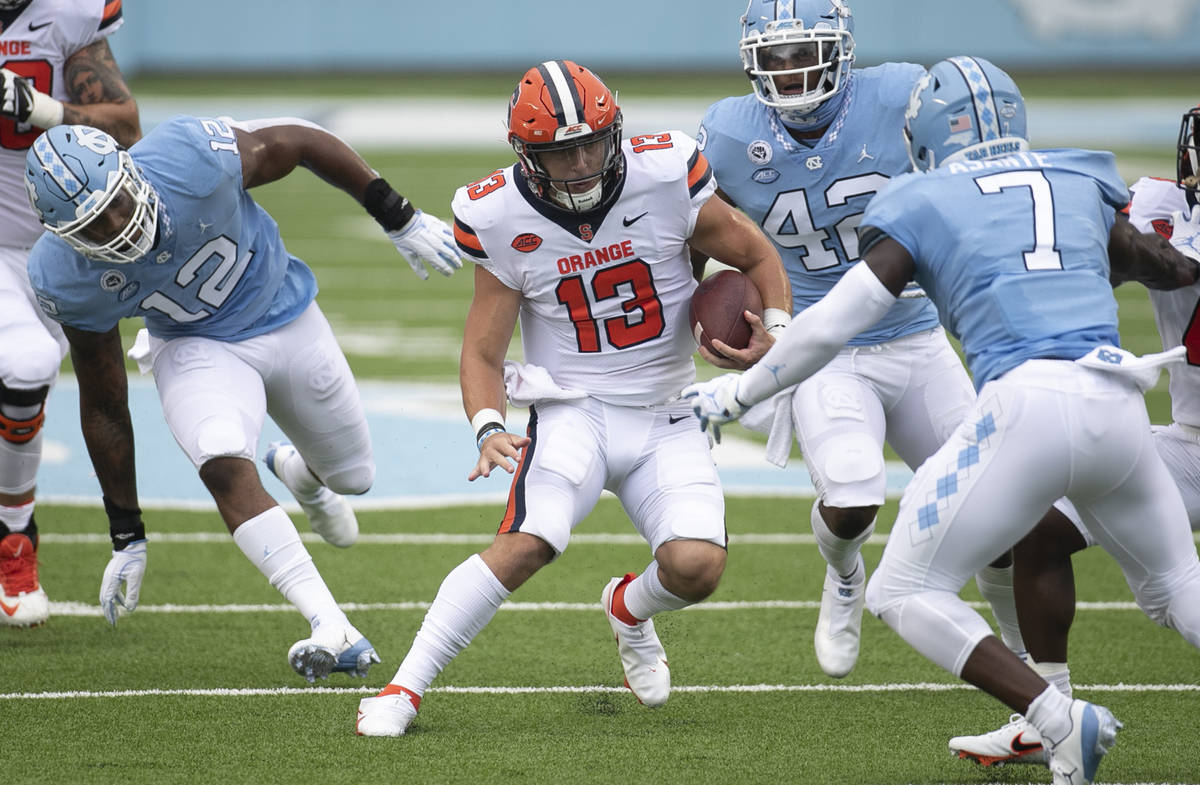 Syracuse quarterback Tommy DeVito (13) looks for running room against North Carolina's Eugene A ...