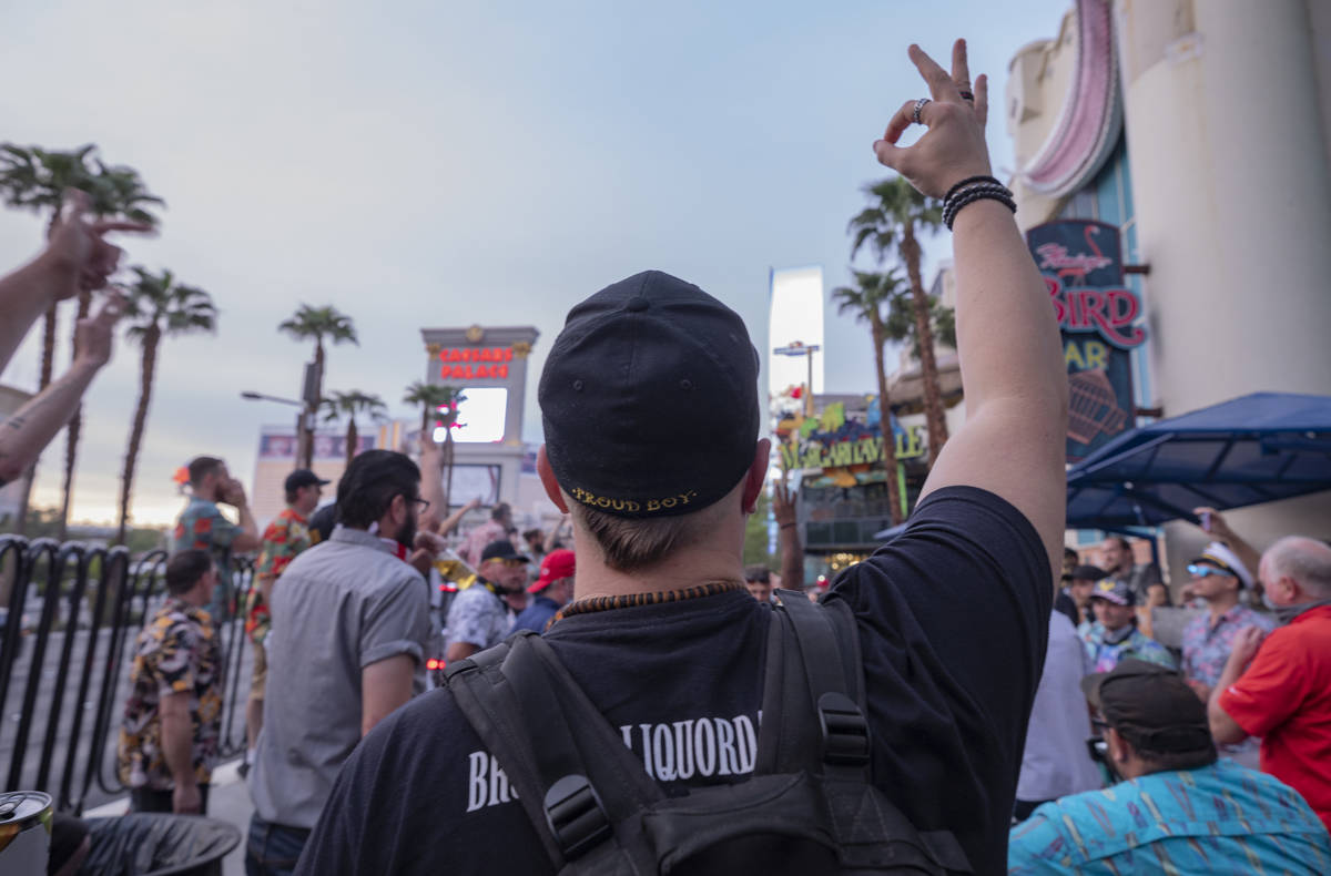 An individual wearing a Proud Boys hat chants “Four more years,” on the Las Vegas ...