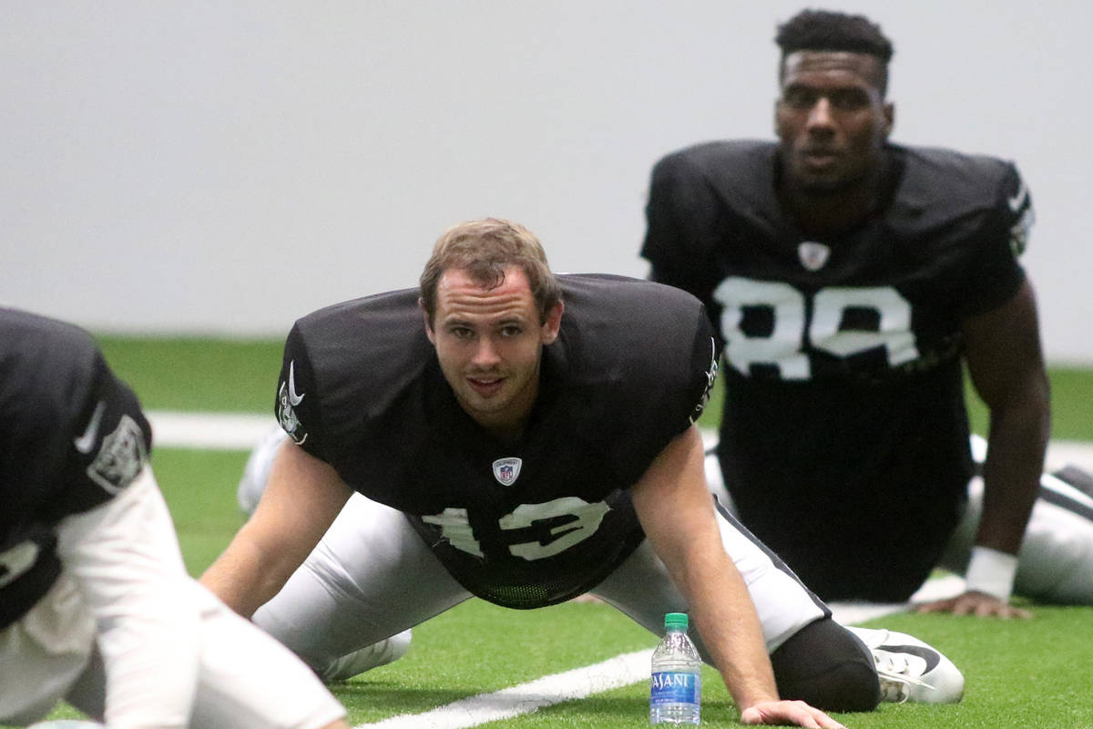 Las Vegas Raiders wide receivers Hunter Renfrow (13) and Bryan Edwards (89) stretch during a pr ...