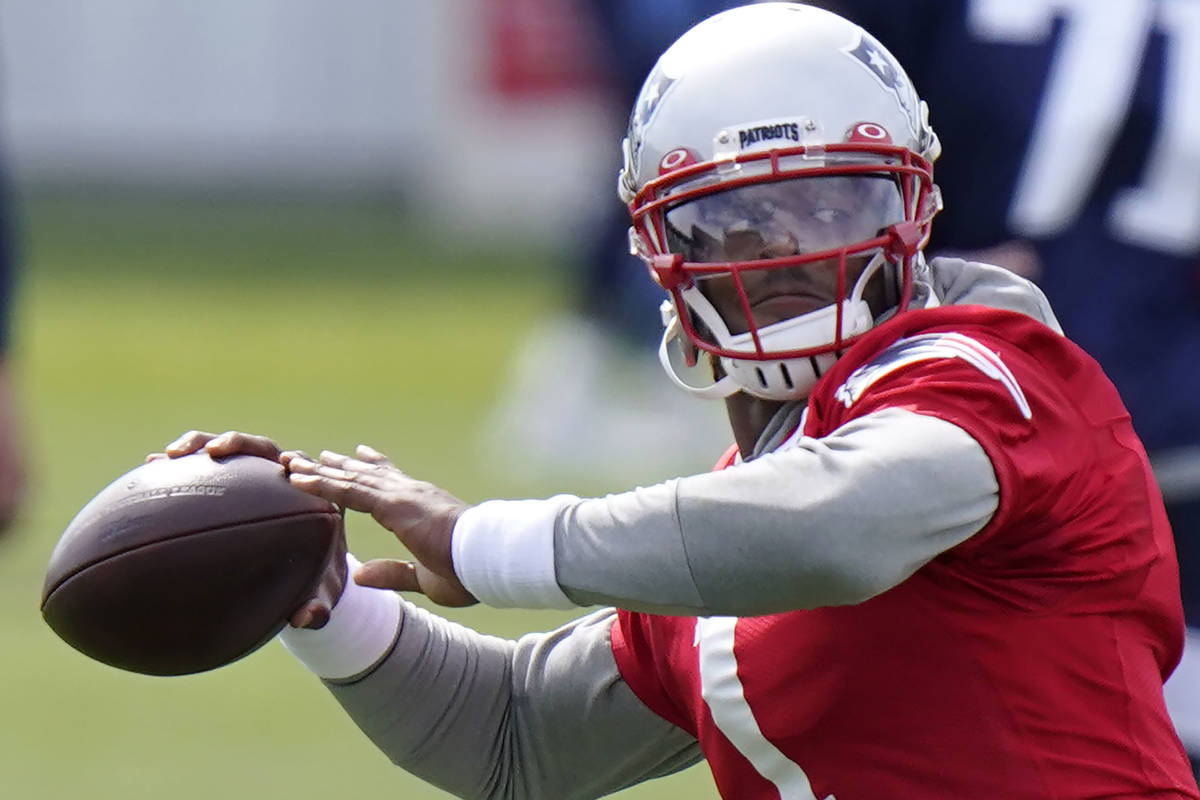 In this Wednesday, Aug. 26, 2020, file photo, New England Patriots quarterback Cam Newton (1) w ...